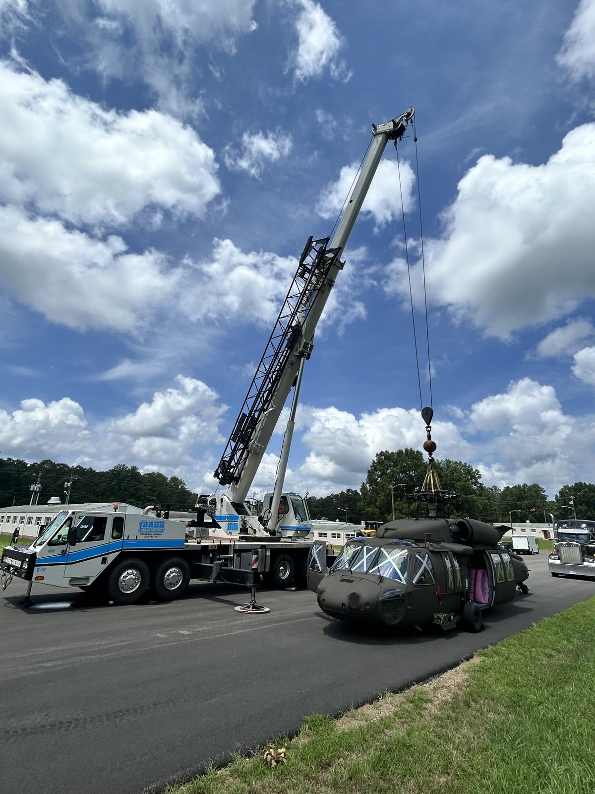 100-ton Bass Crane lifting a military helicopter from a lowboy trailer