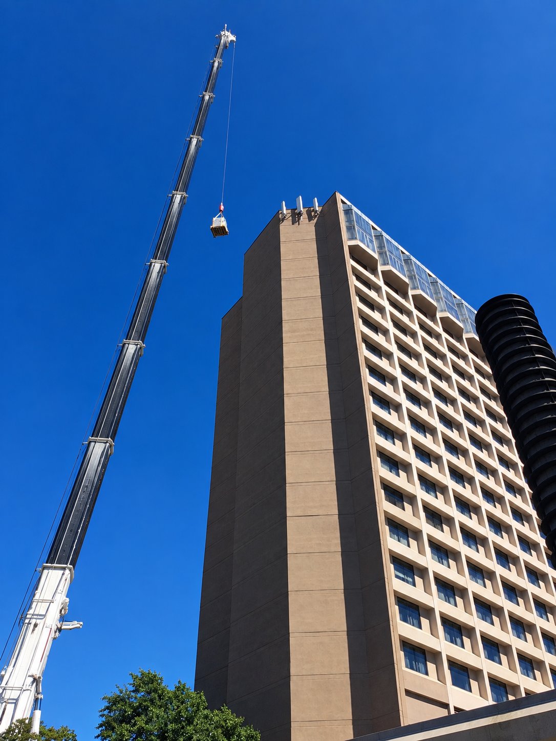 Crane boom extended alongside a downtown Richmond tower