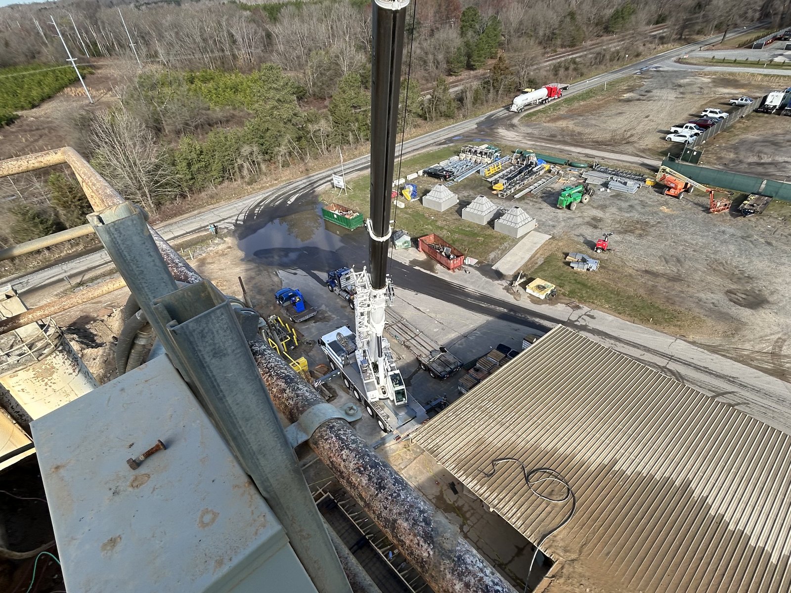 View down the boom from a Bass Crane over a busy industrial jobsite