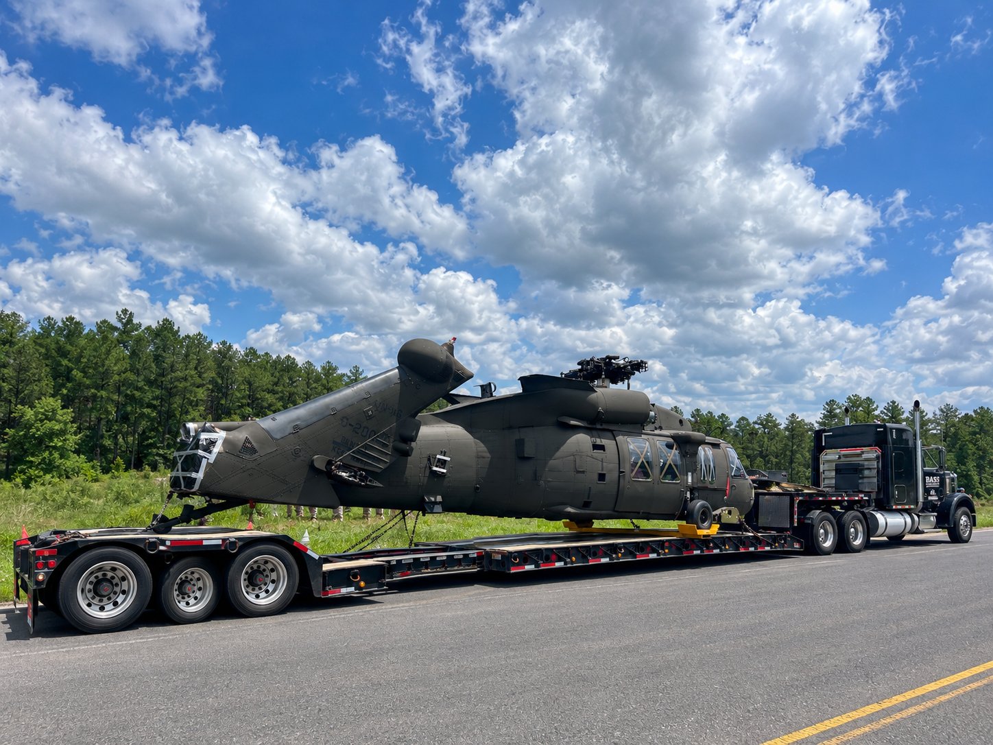 Bass Crane lowboy trailer transporting a military helicopter